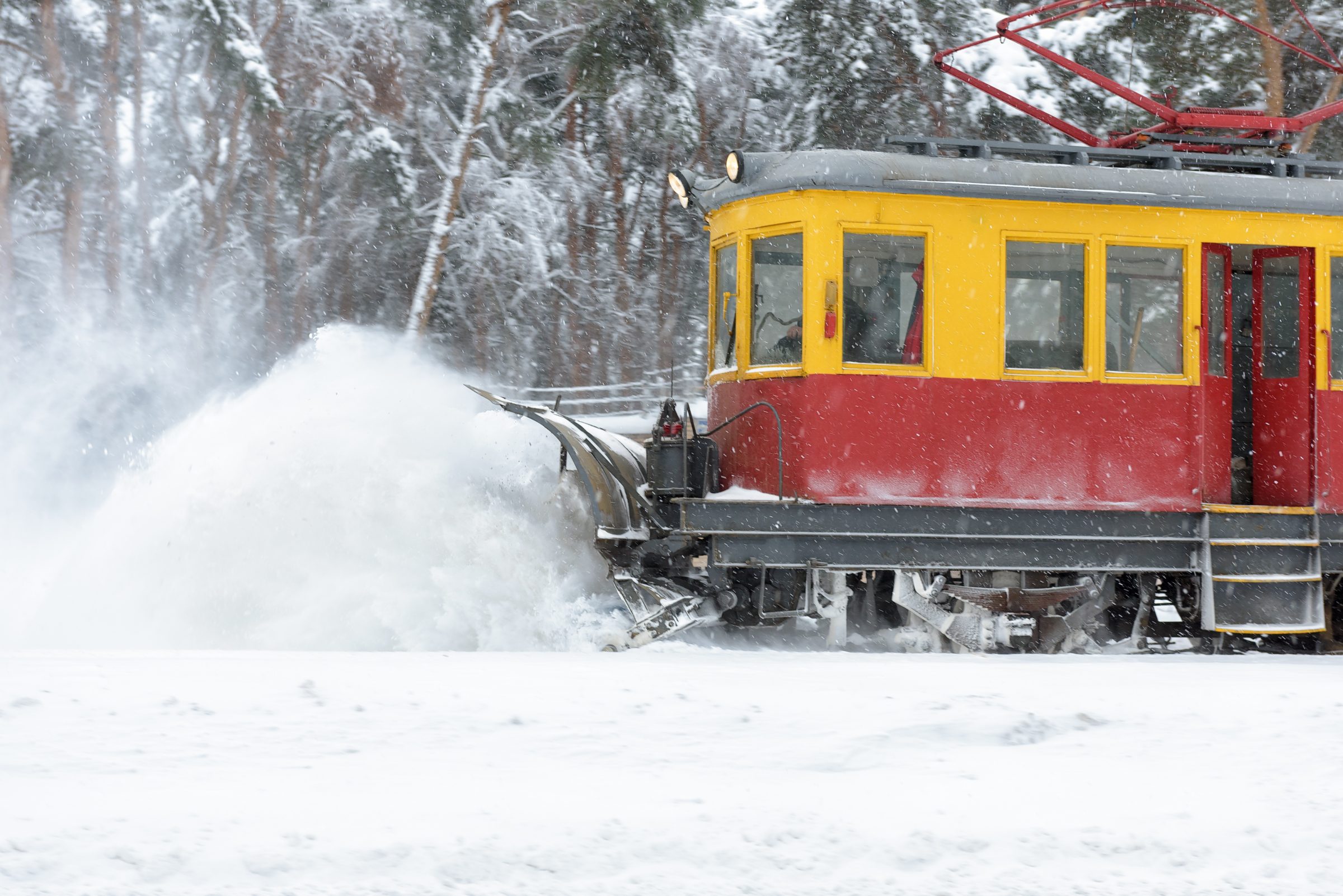 Train clearing snow on tracks during winter storm.