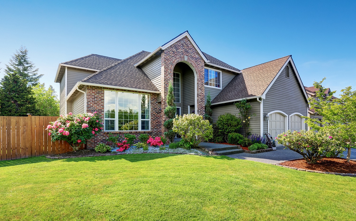 Stylish modern house with lush green lawn.