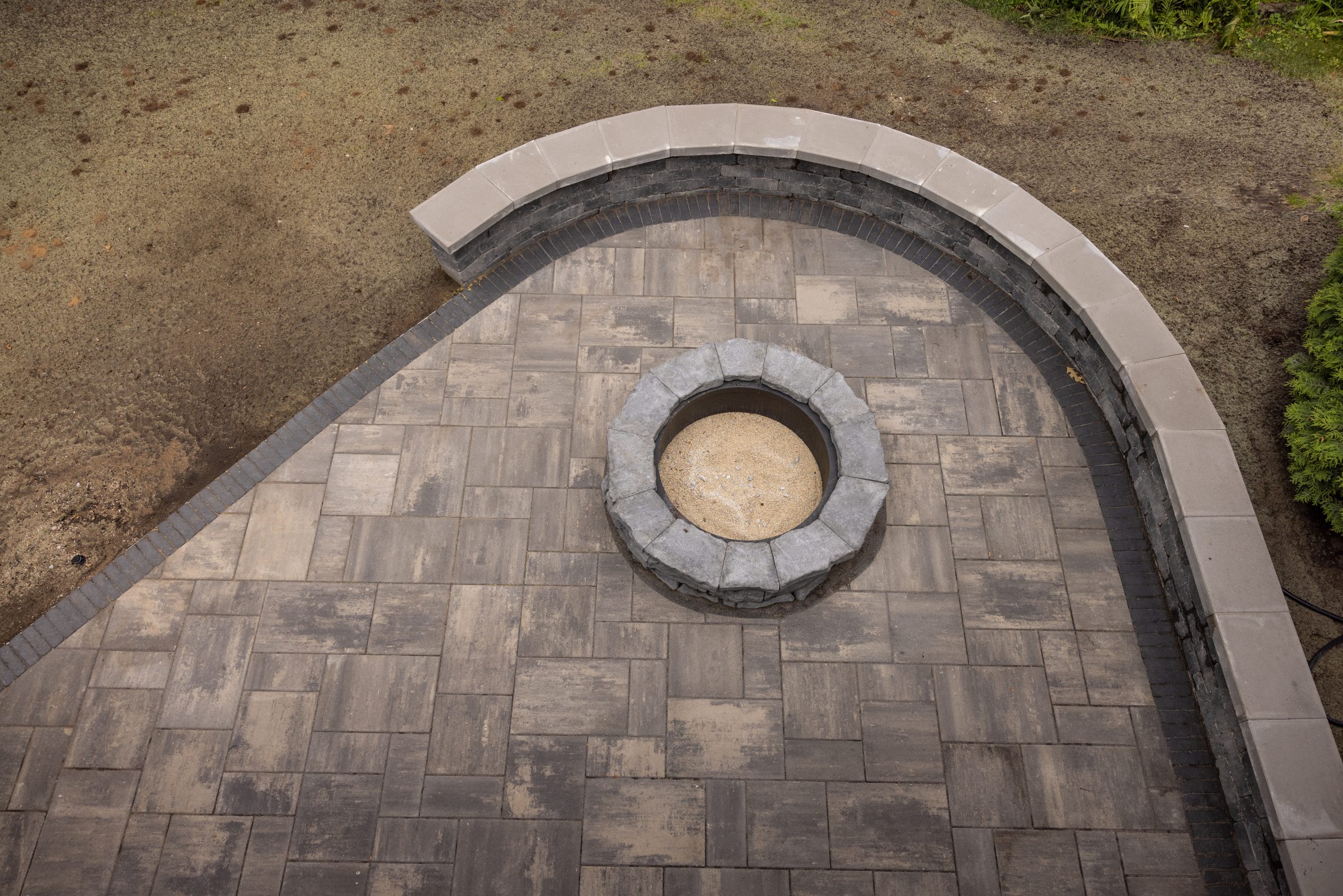 Stone patio with central fire pit design