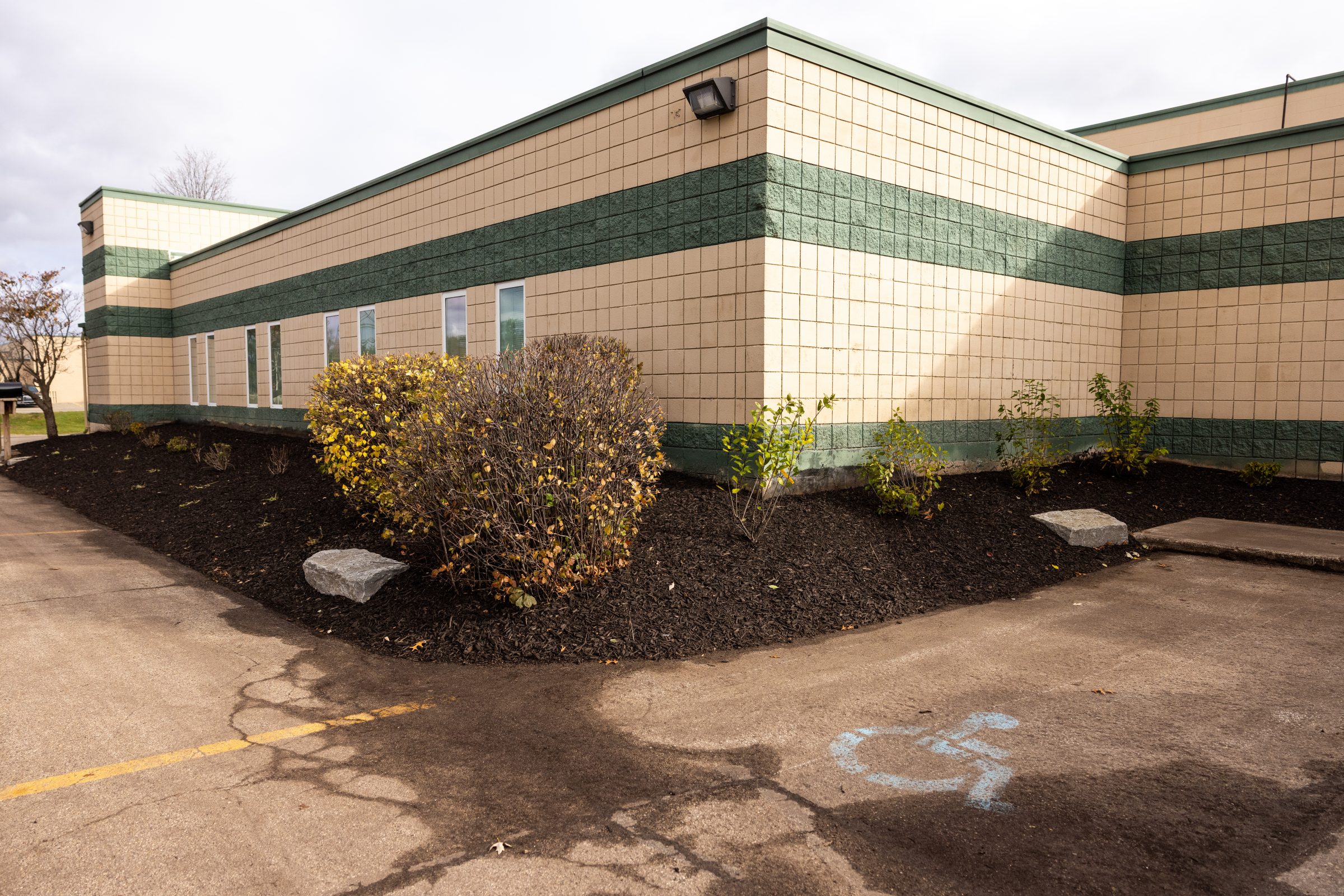 Accessible parking at corner of brick building.
