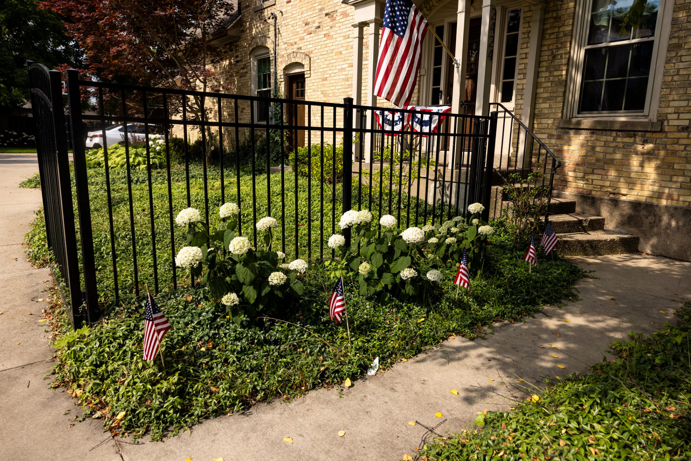 Patriotic home garden with flags and flowers