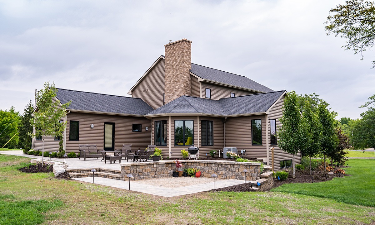 Modern suburban house with large patio area.
