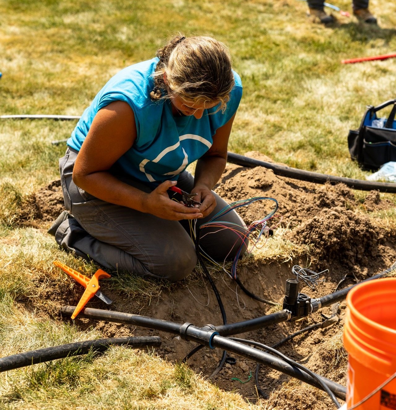 Person repairing underground irrigation system