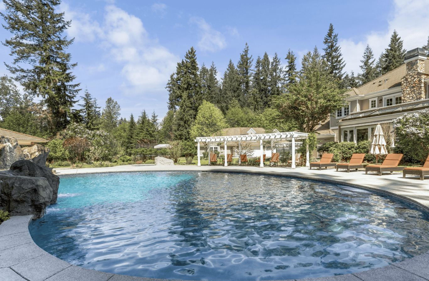 Luxury poolside with loungers and garden view
