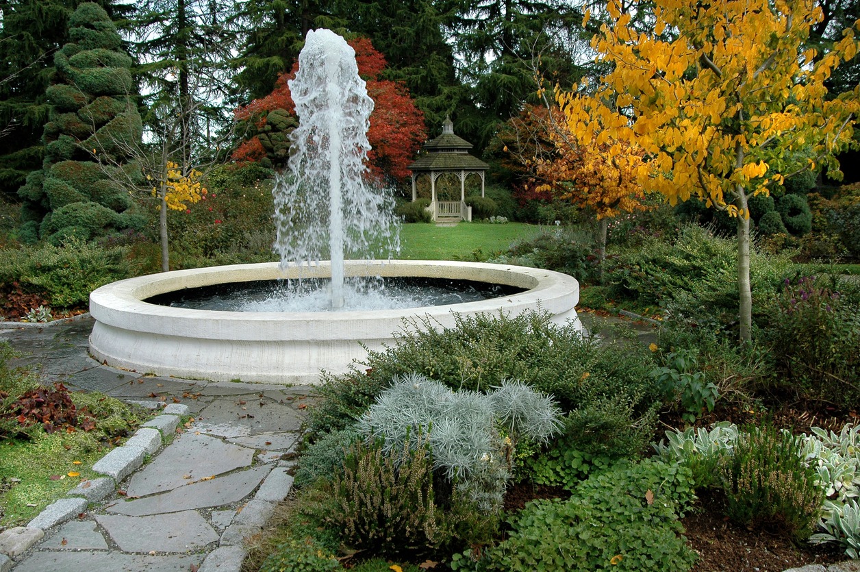 Garden with fountain and gazebo in autumn colors.