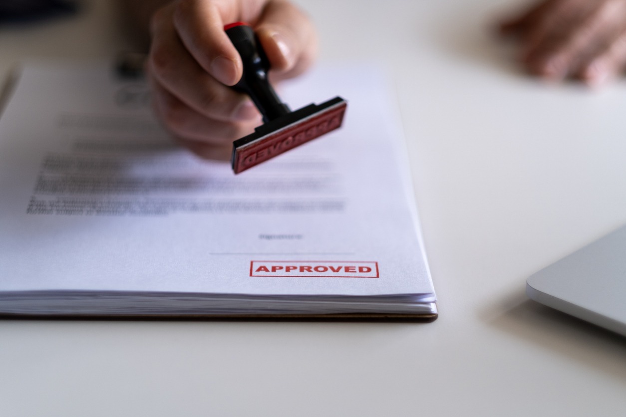 Document stamped with 'Approved,' close-up view.